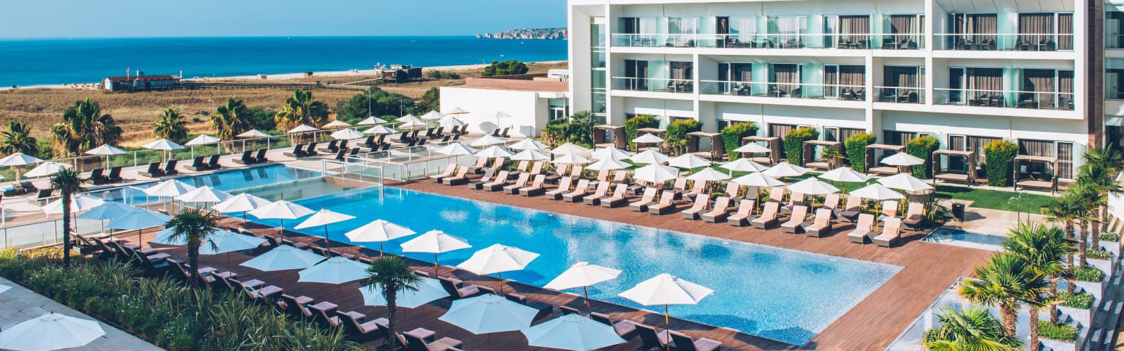 Row of pool cabanas by a beachside pool