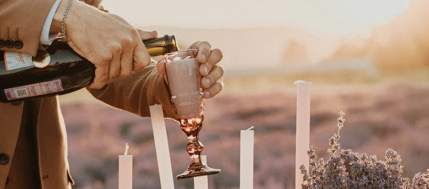 a man pouring champagne into a flute