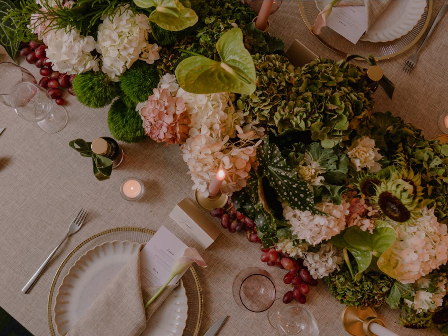 table with bountiful flowers and formal table setting