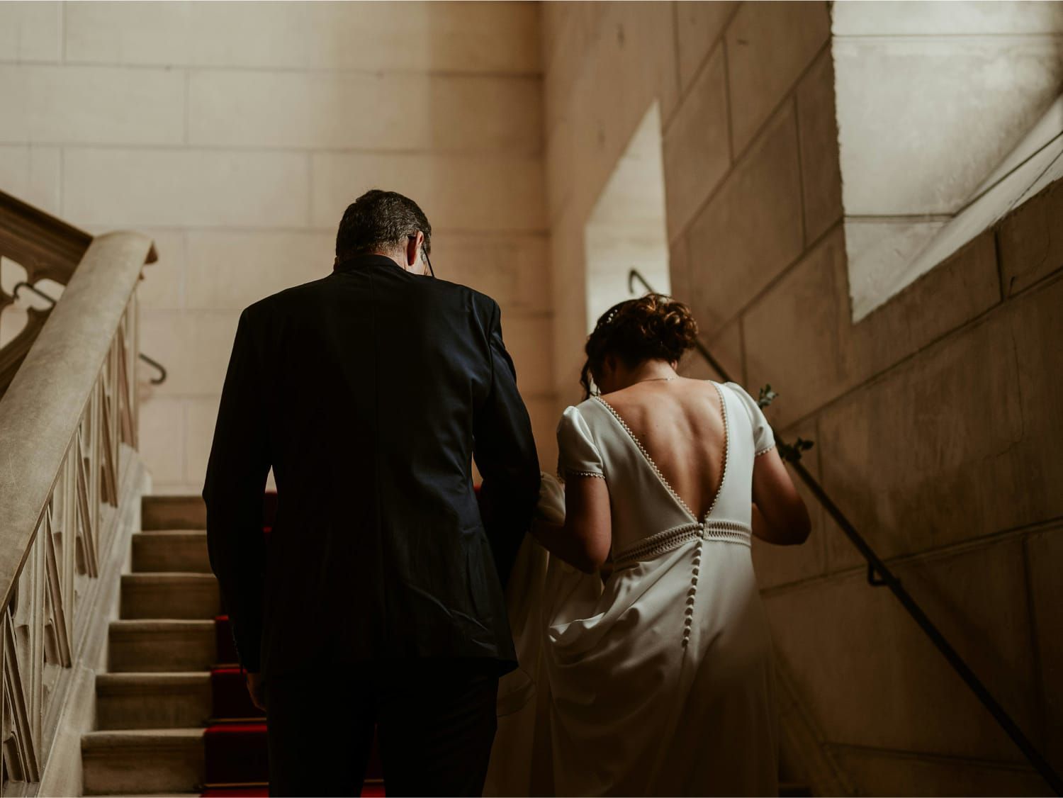 Newly married couple walking up stairs