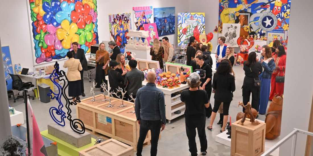 Guests admire the diverse personal art collection at the home of Philip Colbert.