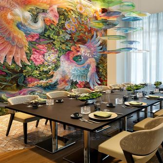 Private dining table next to colorful bird mural in Safina restaurant