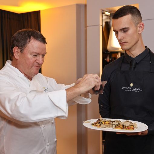 chef putting finishing touches on a plate
