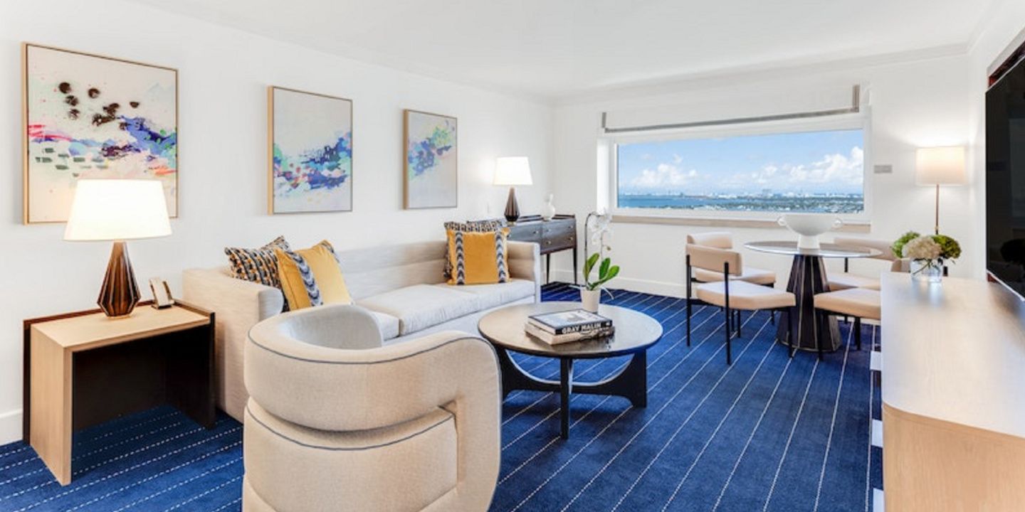 blue and white guest suite with views of miami and ocean