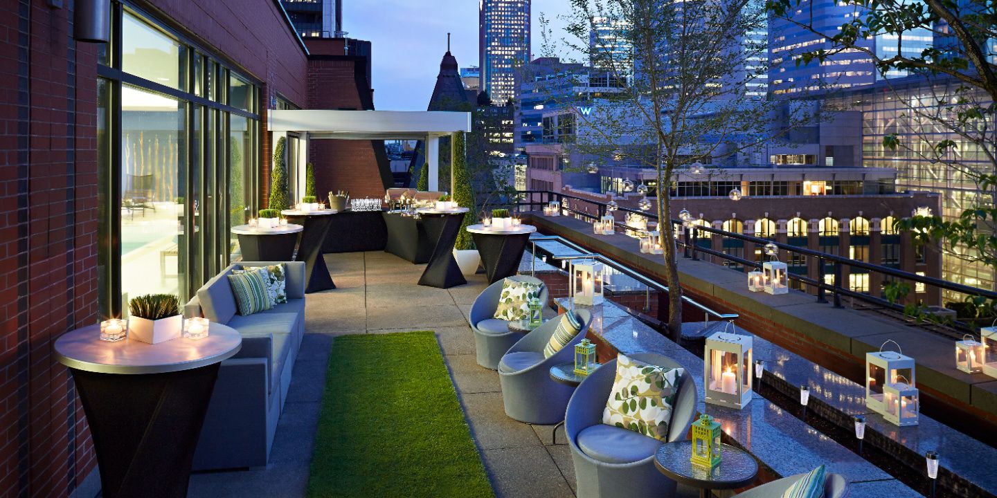 outdoor balcony event space with candlelit tables and montreal views