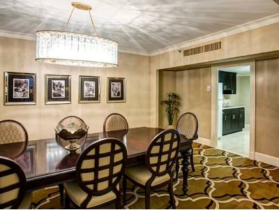 Hotel suite living space with dining table and chairs