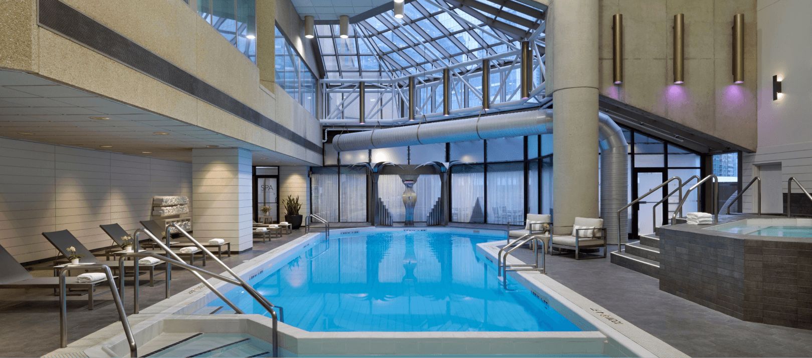 Indoor pool surrounded by lawn chairs