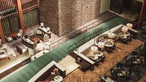Elegant lobby lounge at The Strings by InterContinental Tokyo featuring wood accents and modern tiered seating