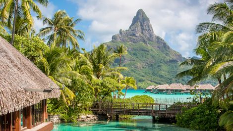 Overwater bungalows and lush greenery at InterContinental Bora Bora Thalasso Spa with Mount Otemanu in the background