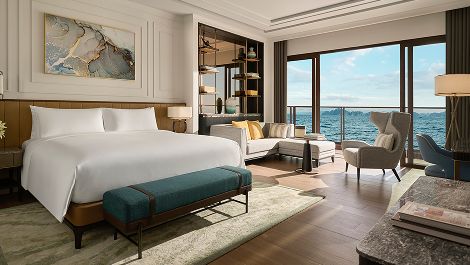 King bedroom with a balcony view of Halong Bay