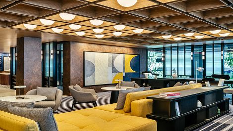 Hotel lobby with spacious seating area of yellow sofas