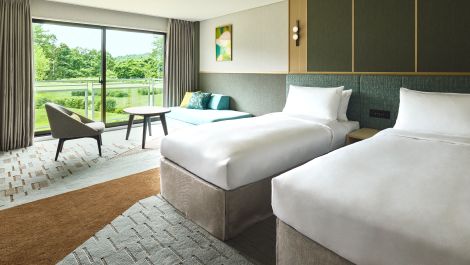 Twin beds with a garden view