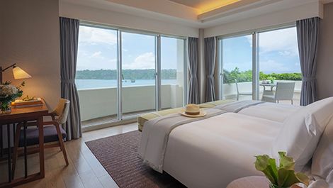 Ocean-view guest room with balcony and seating area