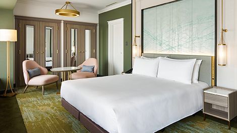 Modern guest room with upholstered seating and city outlook