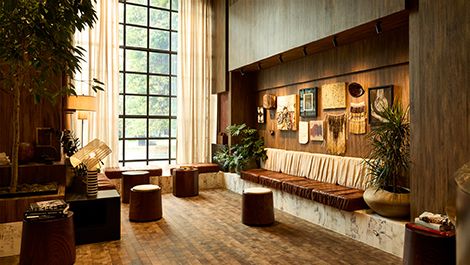 Hotel lobby lounge with warm timber interiors and artwork