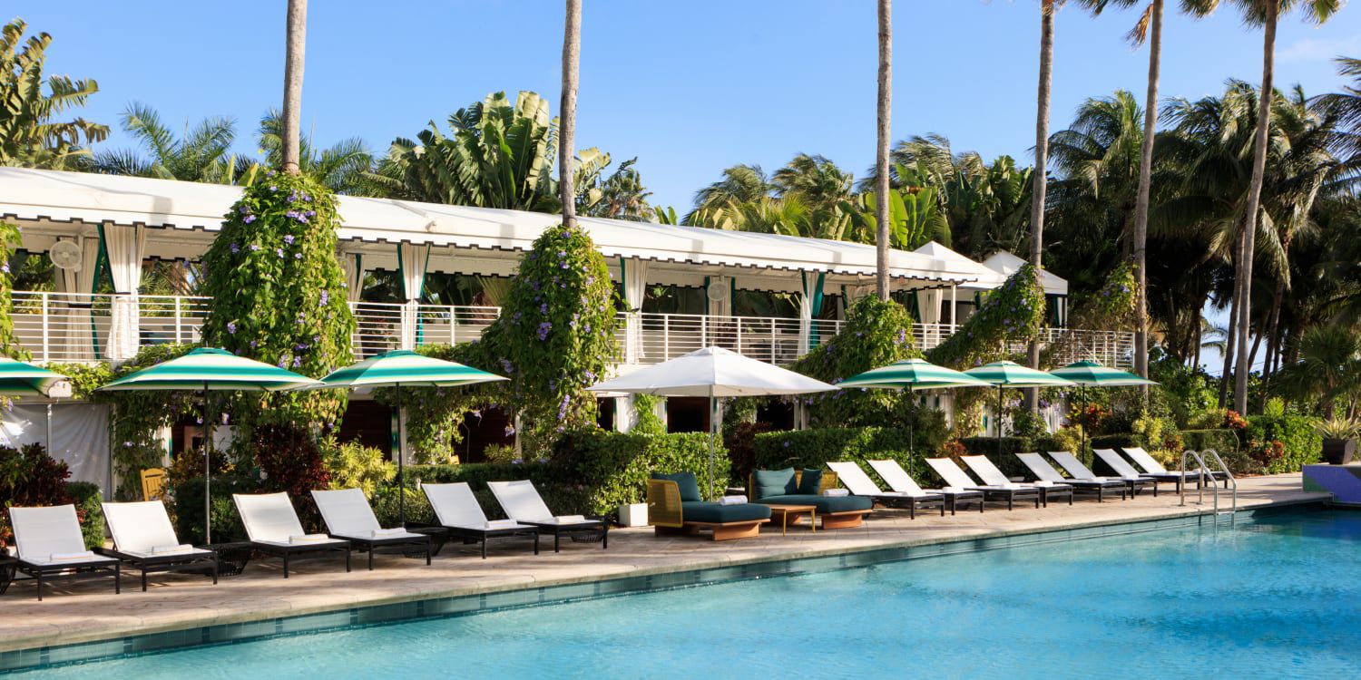 Lounge chairs lining a swimming pool, the perfect place for last-minute travel