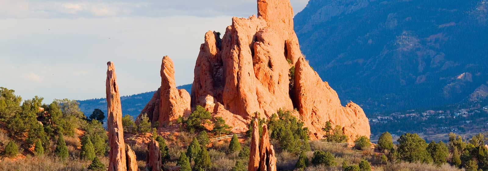 Red Rock formation in front of a valley and mountain