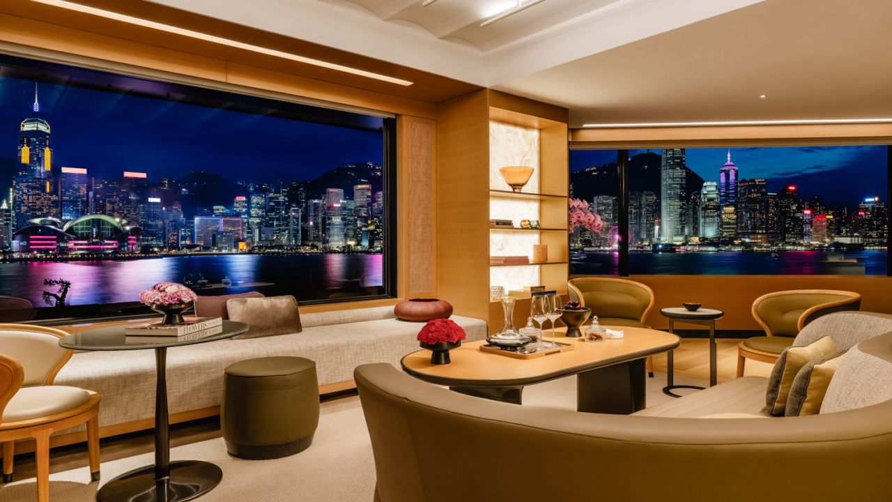 large suite with living room overlooking city lights of hong kong