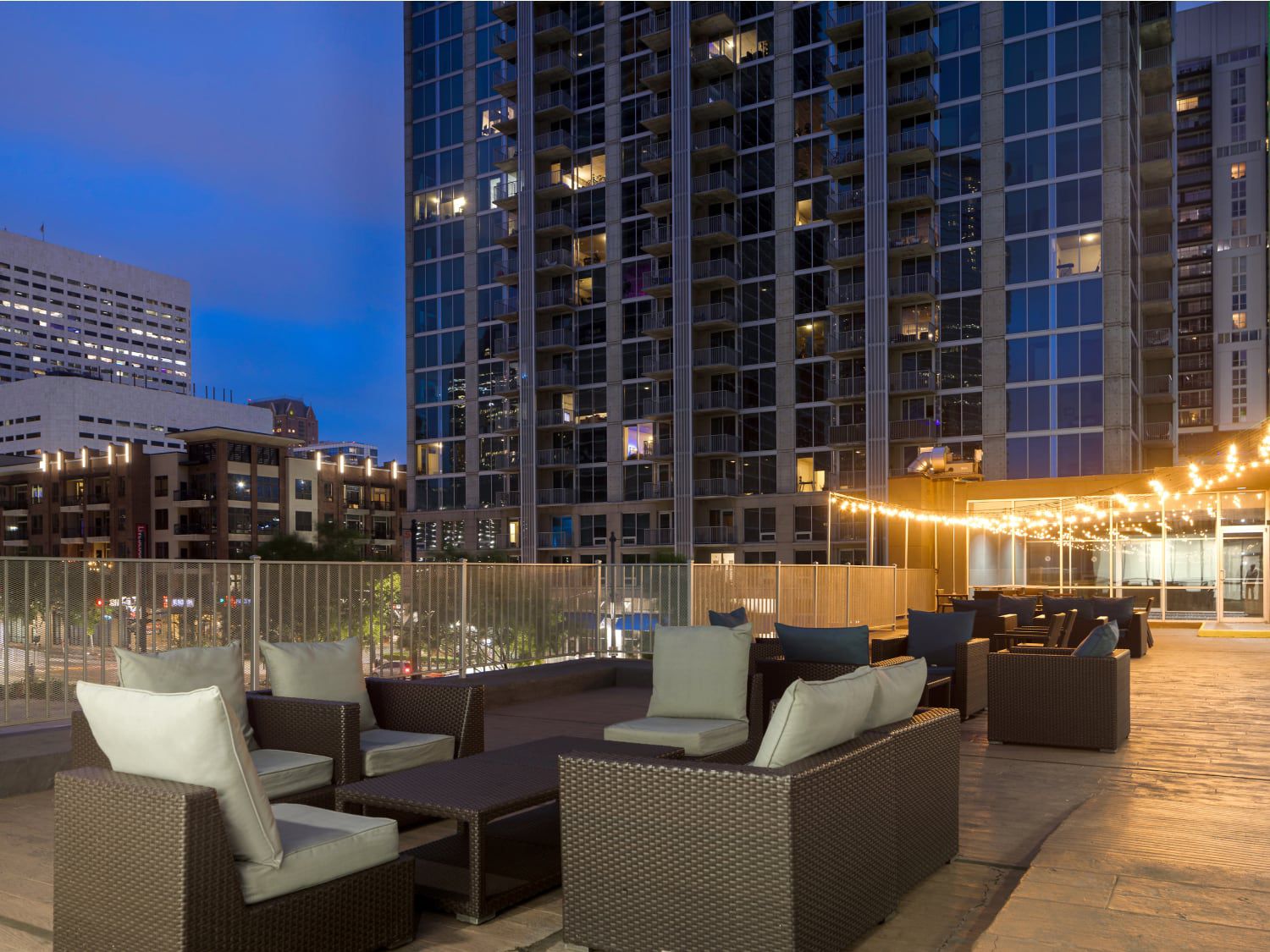Rooftop-style terrace with tables and urban skyline