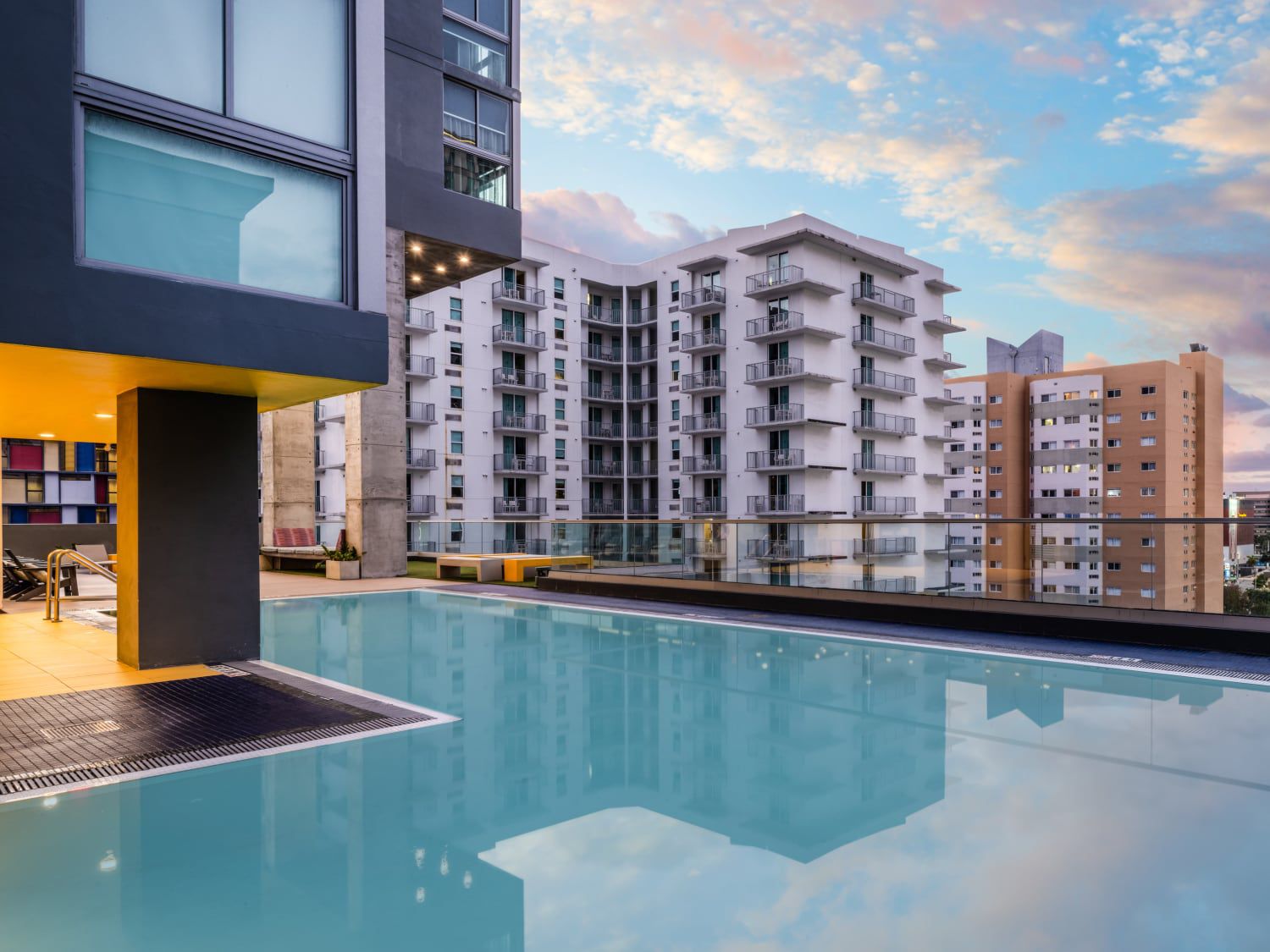 Outdoor hotel pool overlooking an urban skyline