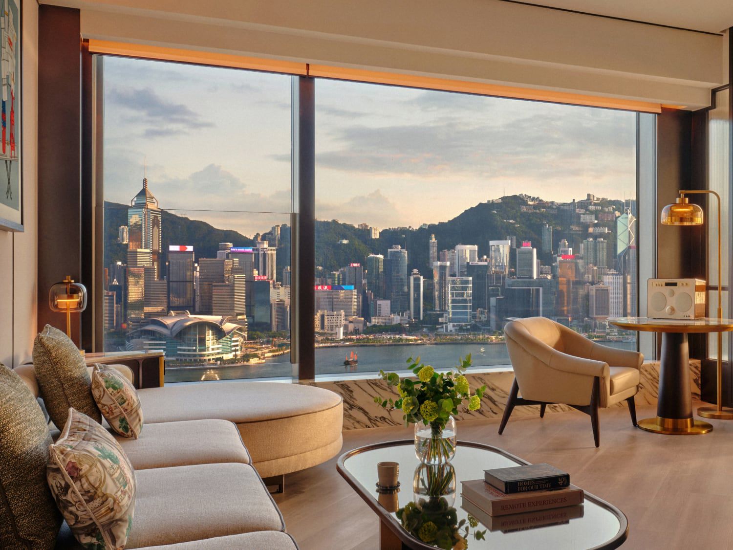 Luxury hotel suite with floor‑to‑ceiling windows and city view