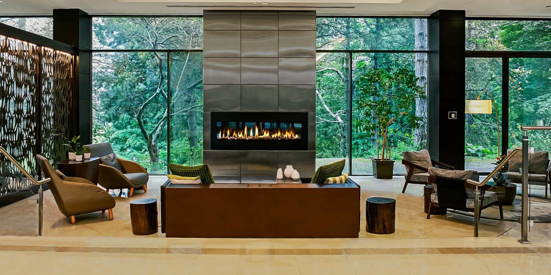 Modern hotel lobby with fireplace and lounge seating