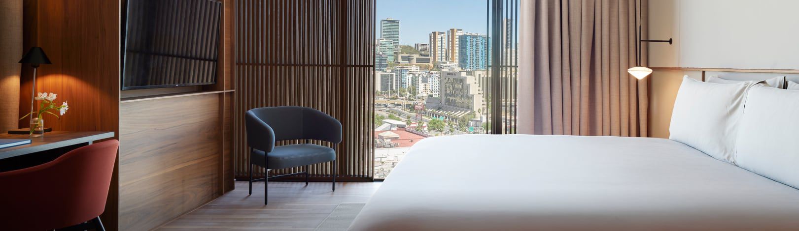 Hotel bedroom overlooking downtown skyline