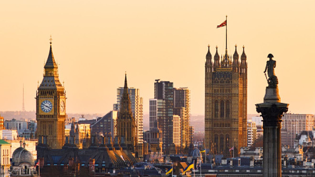 London skyline at golden hour, featuring Big Ben and the Houses of Parliament along the River Thames