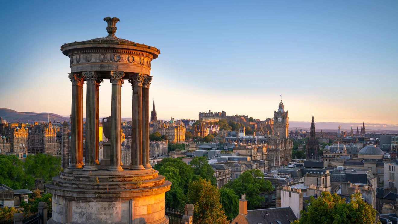 Edinburgh's Calton Hill monument silhouetted against a warm dusk sky