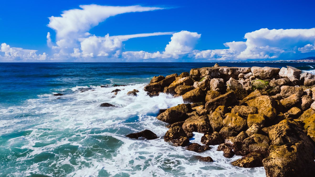 Waves crashing along Lisbon's rugged coastal cliffs
