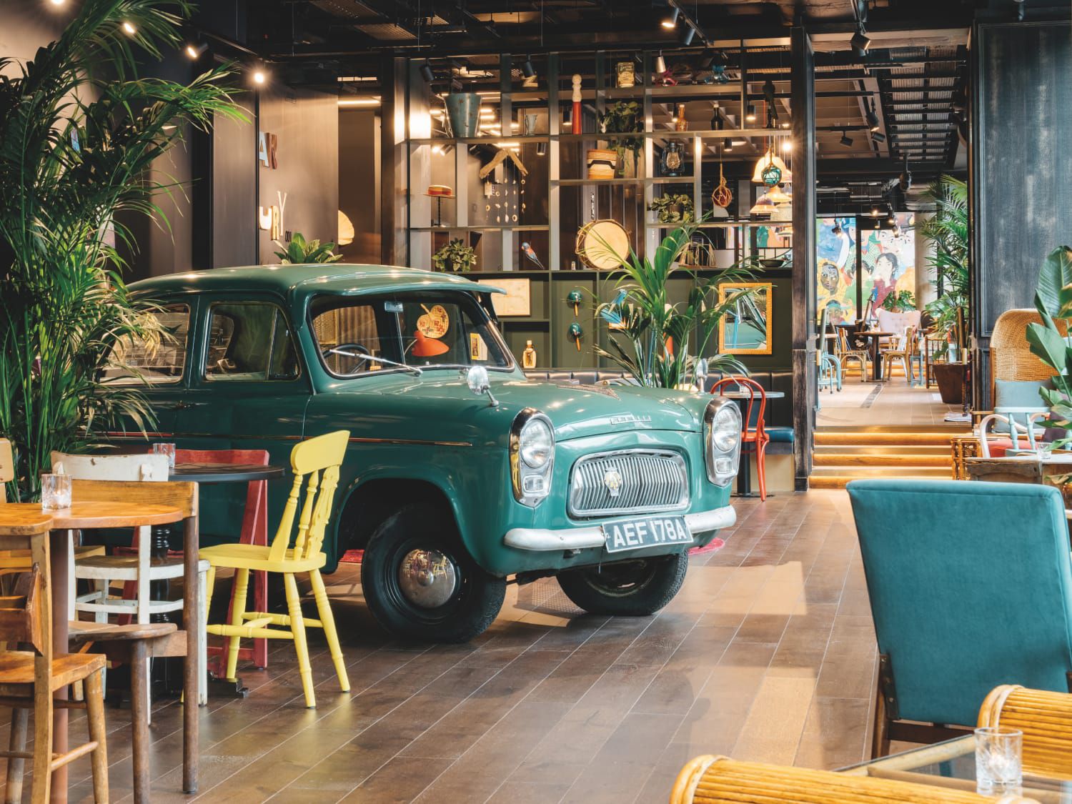 The Caribbean-inspired lounge area at Ruby Zoe Hotel London includes a vintage car.