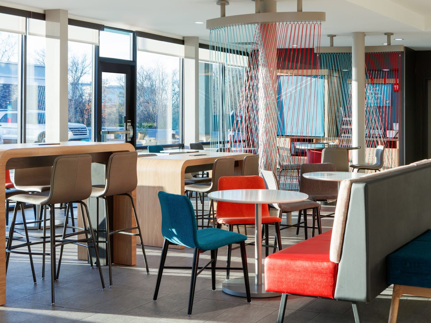 The common space at avid Hotel Nashville Airport, accented in avid's signature teal and orange.