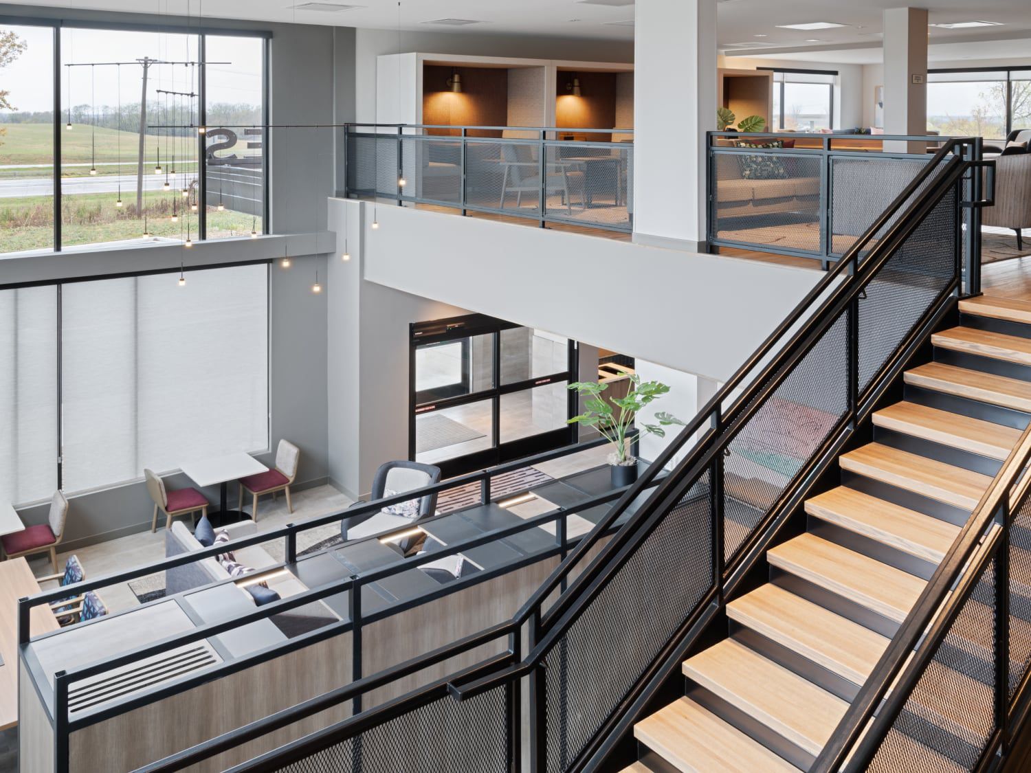 First floor restaurant with staircase to second floor working space