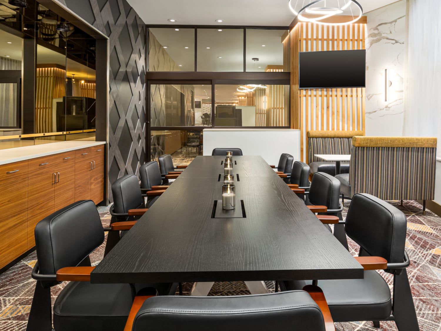 Meeting space with long table and ten chairs