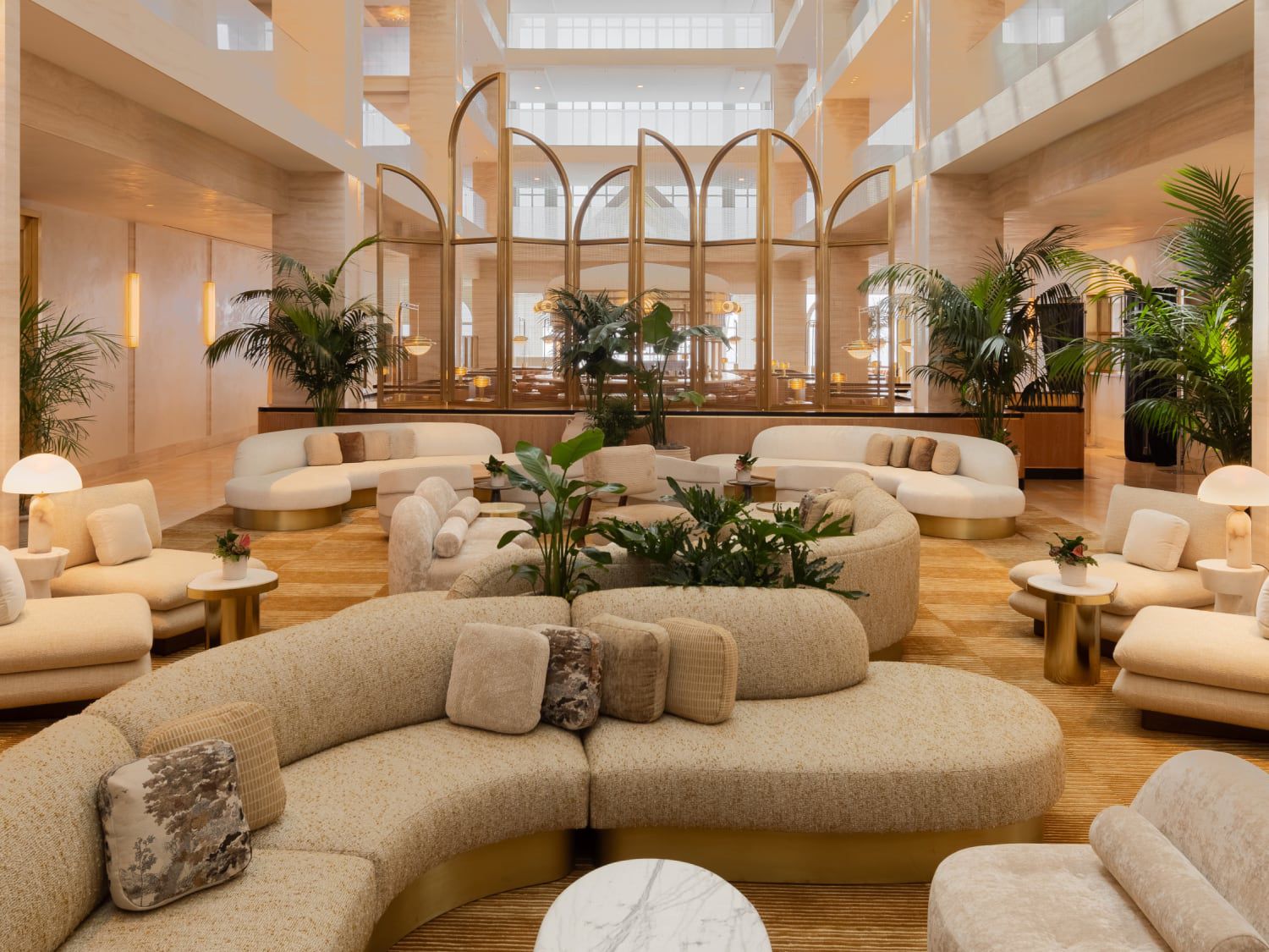 Hotel lobby with curved furniture and greenery
