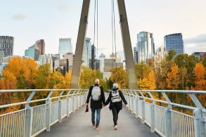 A couple walking across a bridge in Calgary
