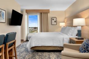 A clean and modern hotel room overlooking the city