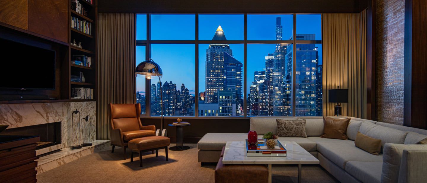 Warm woods and leather along with cool marble tones set the scene in this contemporary living area with expansive city views.