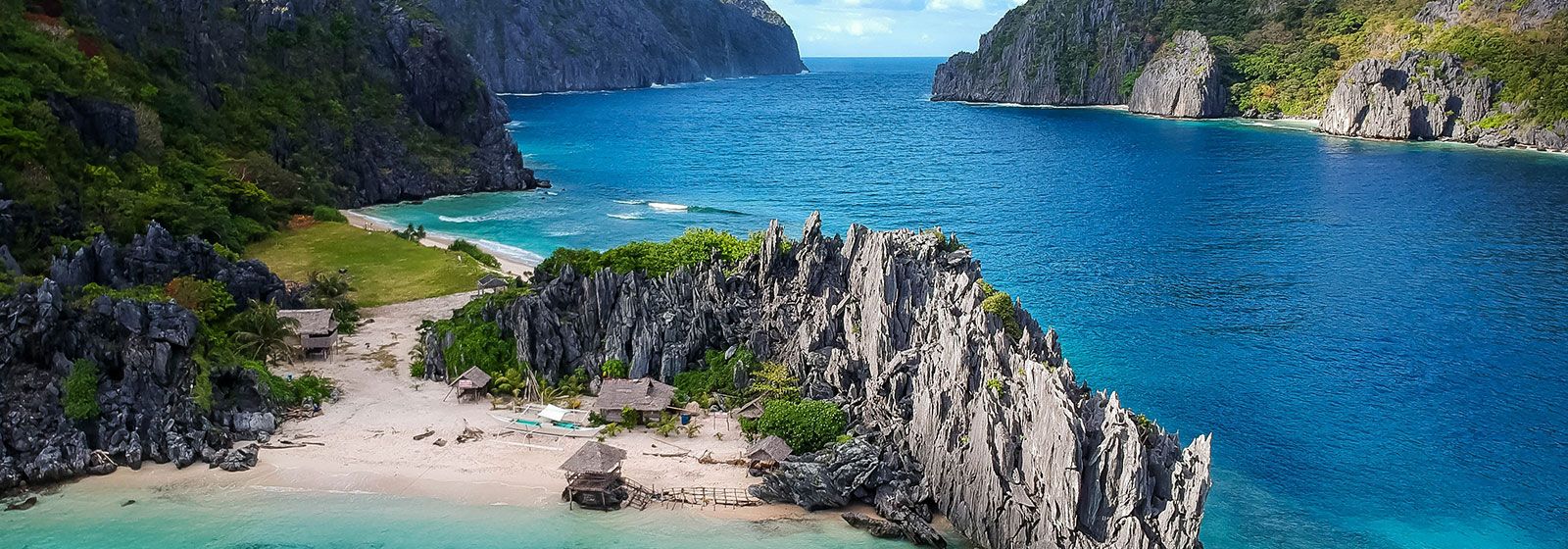 Winding blue river surrounded by cliffs with green foliage 