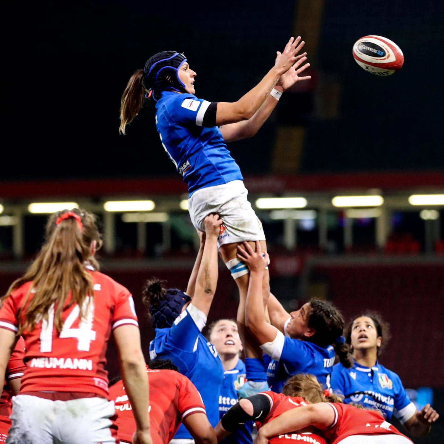 Nine Female Rugby players on the pitch mid match at the Guinness Women's Six Nations