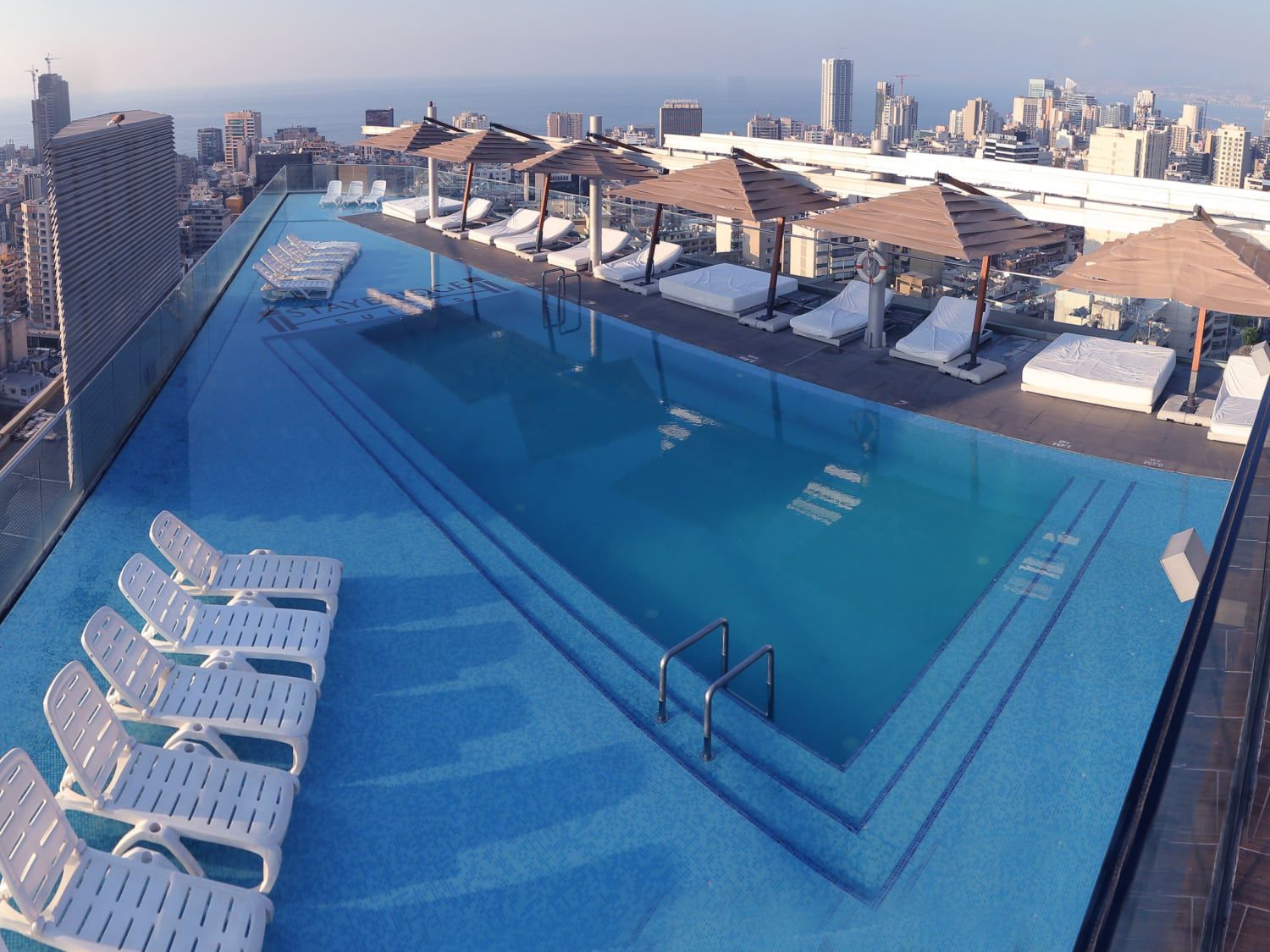 Rooftop pool, lounges, and day beds at Staybridge Suites Beirut