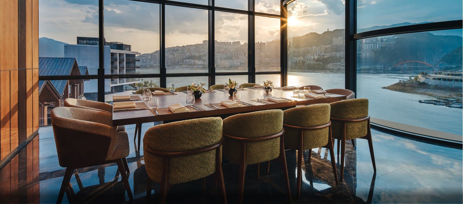 Dining table with stunning water views at HUALUXE Chongqing Wushan