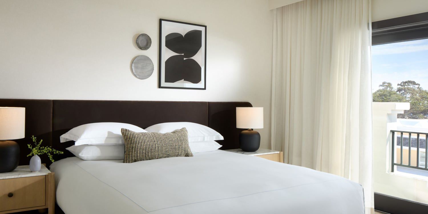 Clean modern bedroom with crisp, white linens.