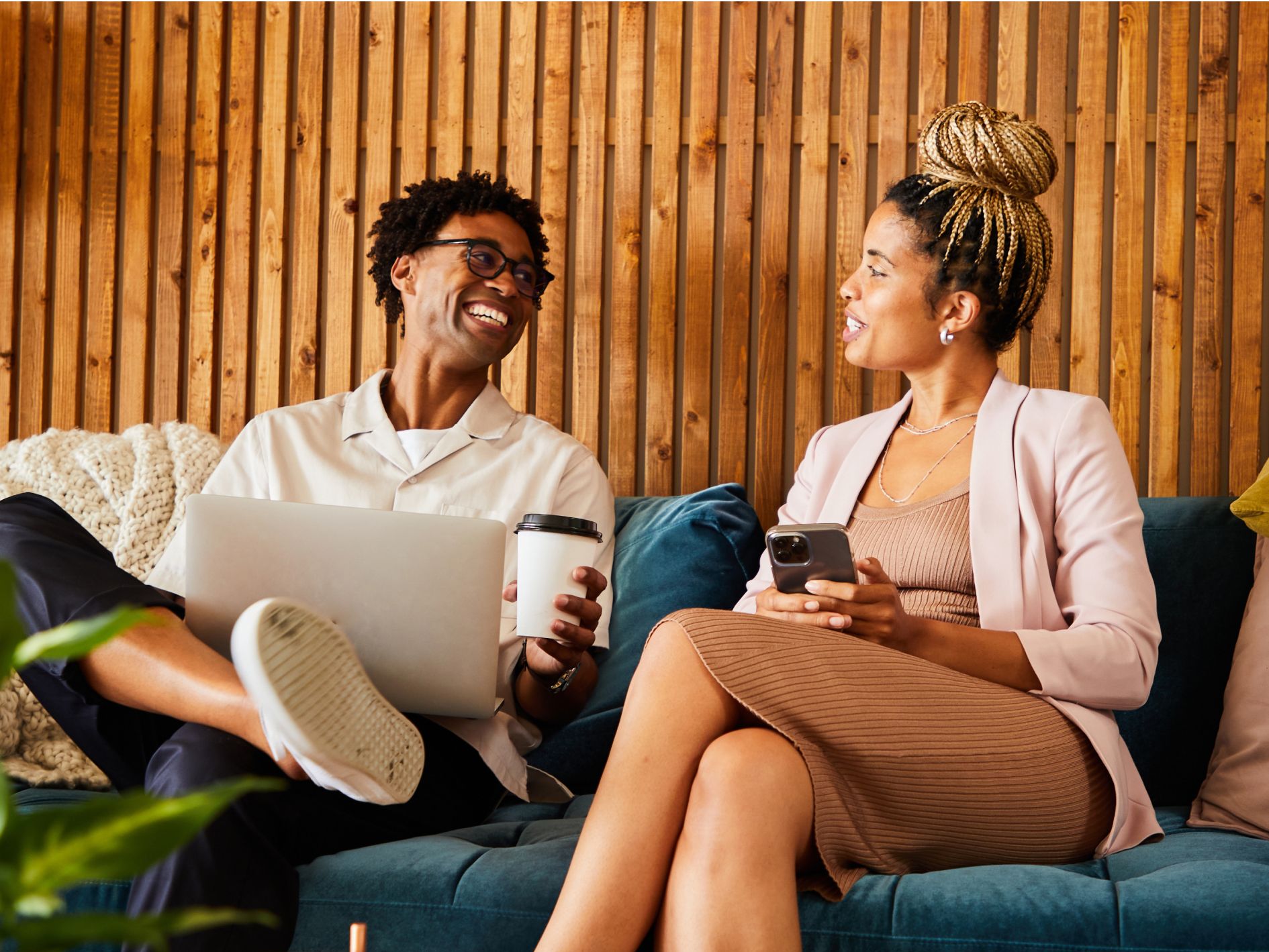 A person and person sitting on a couch