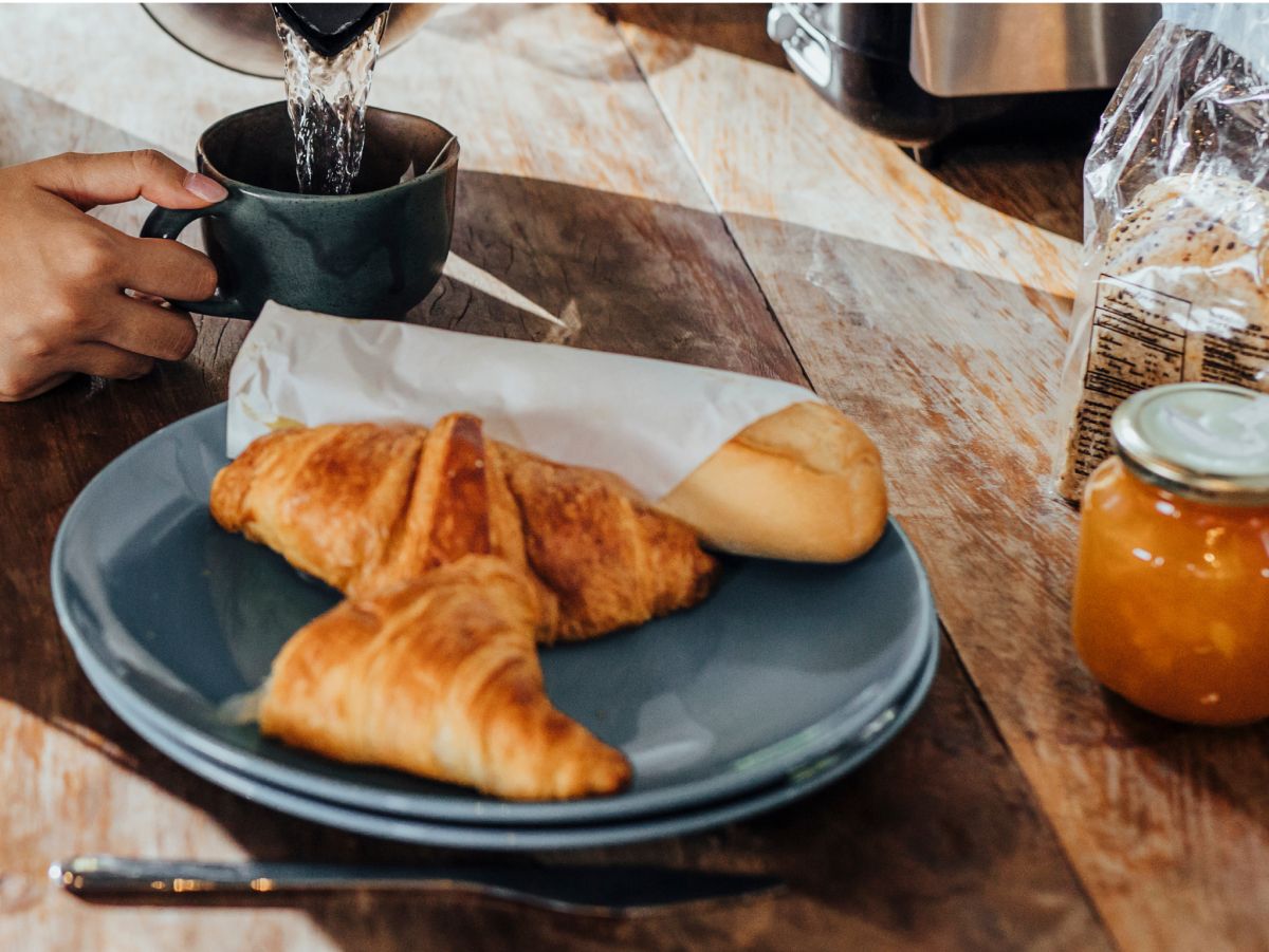 A plate of croissants and a cup of coffee