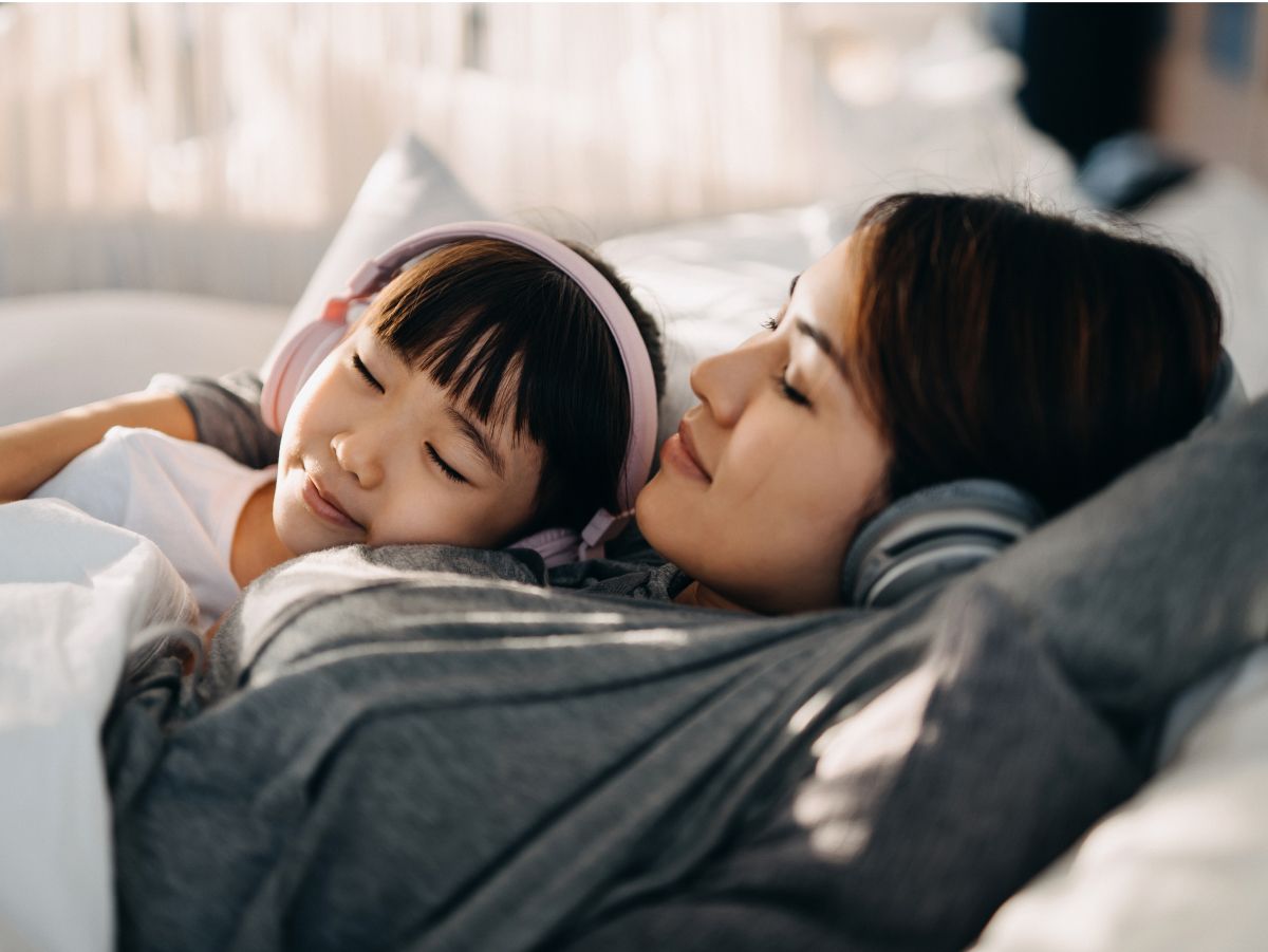 ベッドに横たわっている人物と子ども