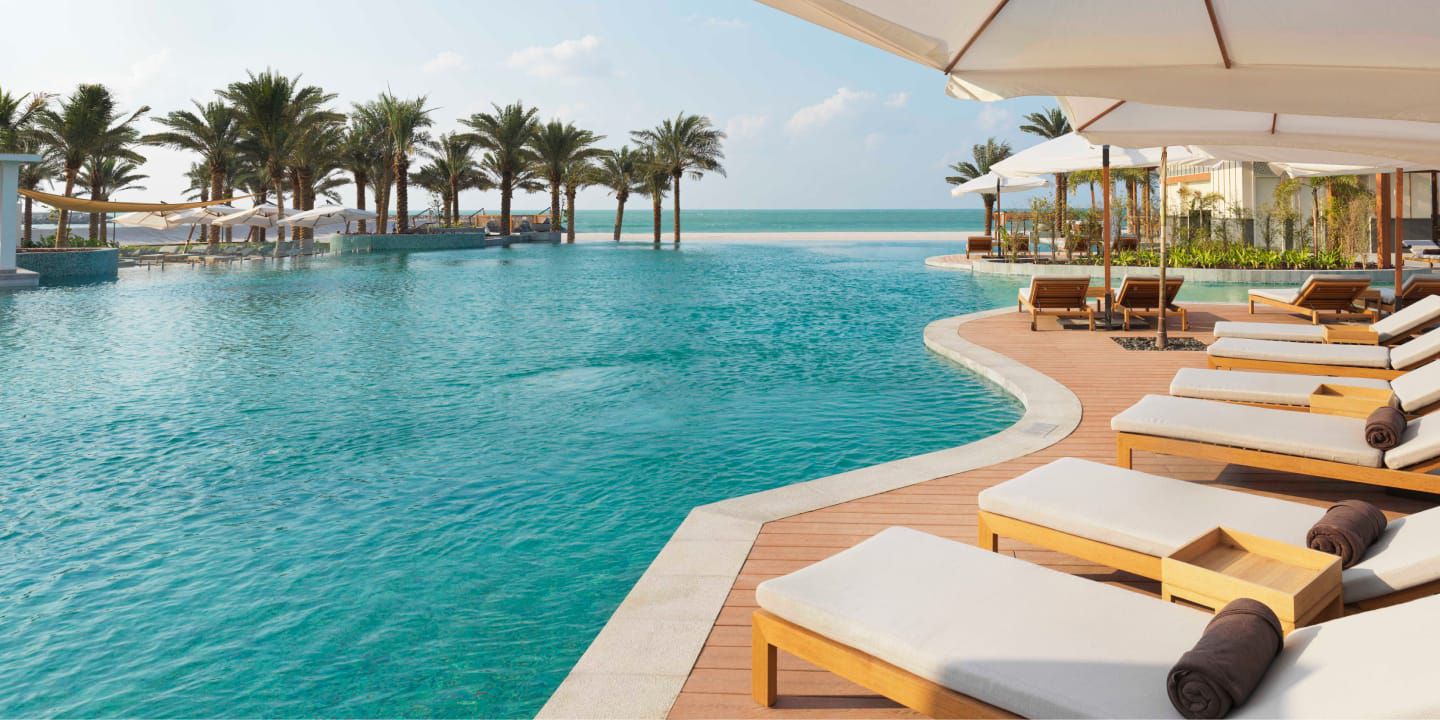 Chairs alongside an infiniti pool overlooking the ocean