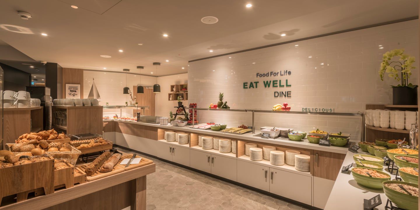 Hotel buffet with breads, salads, and fresh food selection.