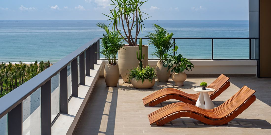 serene balcony views of lush island foliage and endless blue sea