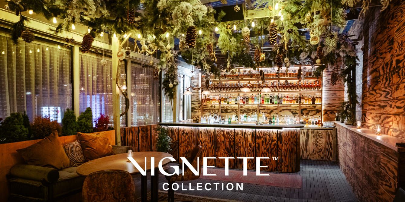 restaurant lounge with dramatic evergreen and pinecone decor across the ceiling